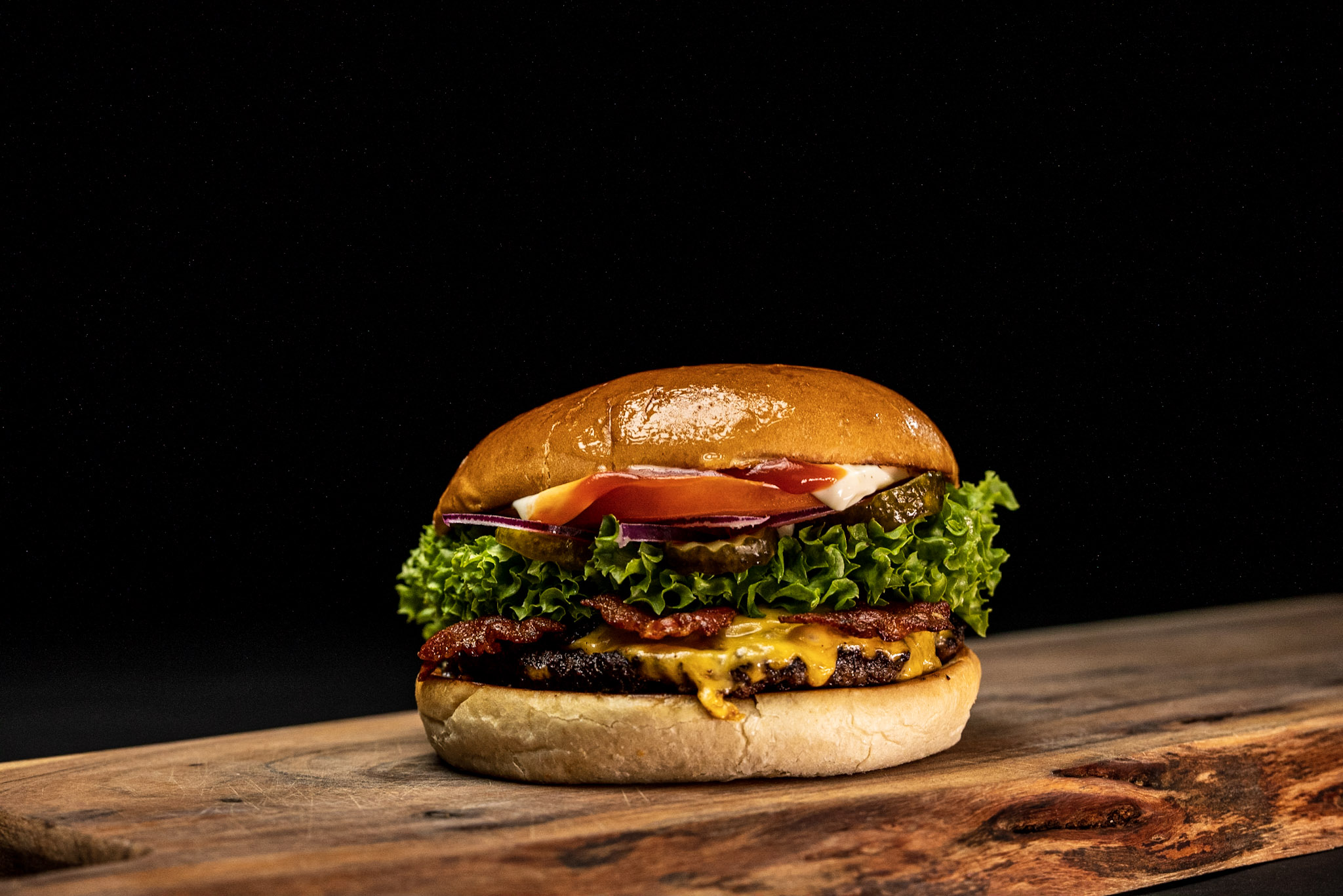 Flip The Burger restaurant exterior in Kolding, showing bold white logo above large windows — known for the best burgers in town.
